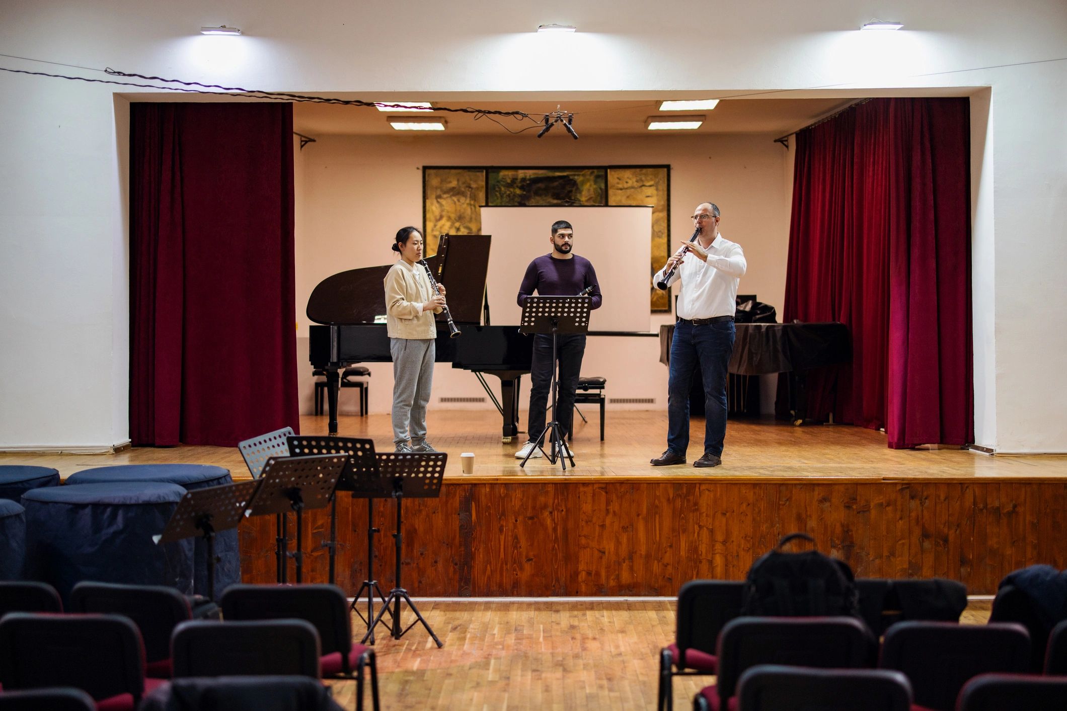 Instructor working with students during a music lesson